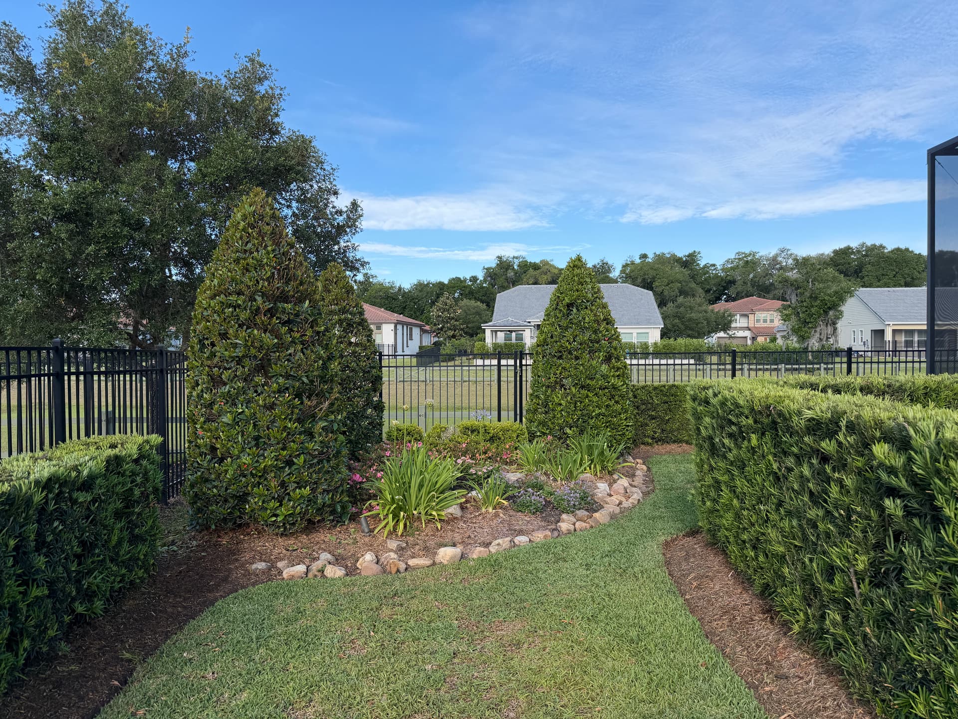 Hand-shaped topiary garden with sculpted shrubs and stone borders