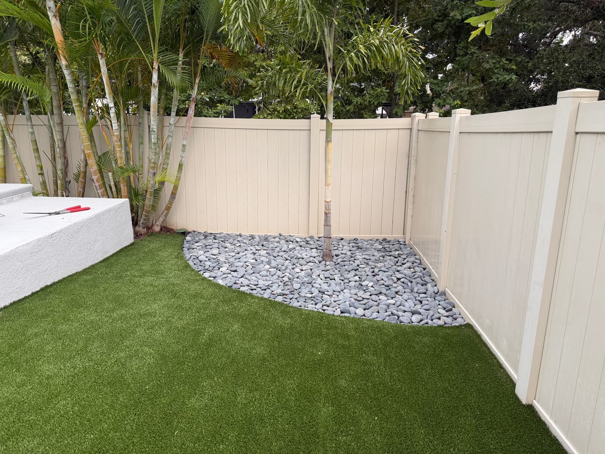 Backyard turf and decorative river rock detail