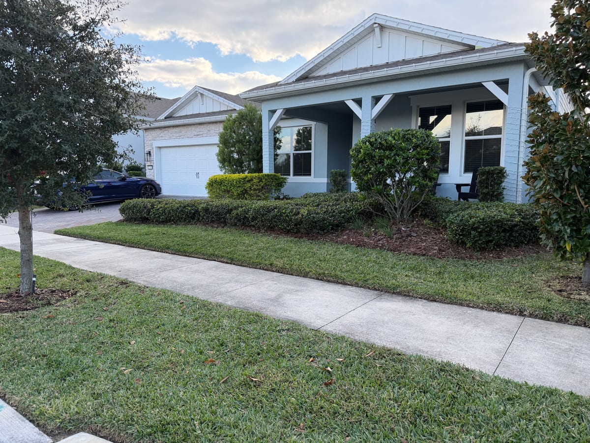 Bungalow with hedge-trimmed front beds and clean walkway